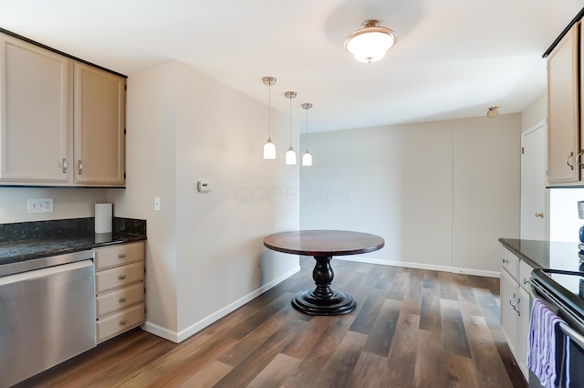 kitchen with stainless steel appliances, dark wood-type flooring, pendant lighting, dark stone countertops, and cream cabinetry