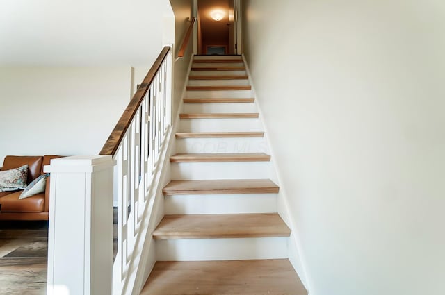 staircase with hardwood / wood-style flooring