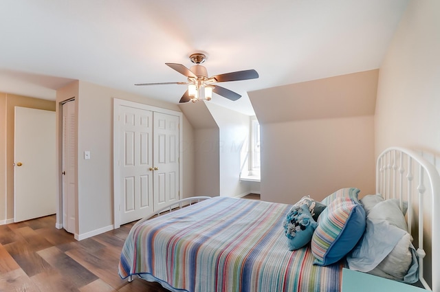 bedroom featuring wood-type flooring, two closets, and ceiling fan