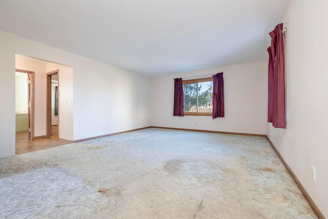 unfurnished room with light colored carpet