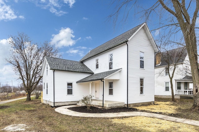 rear view of house featuring covered porch