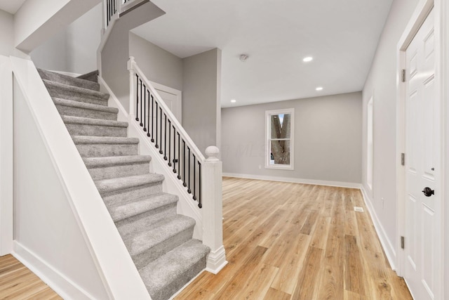 staircase featuring wood-type flooring