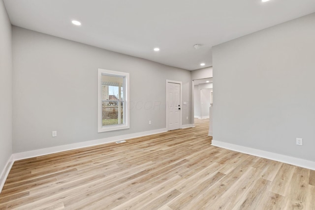 unfurnished room with light hardwood / wood-style flooring