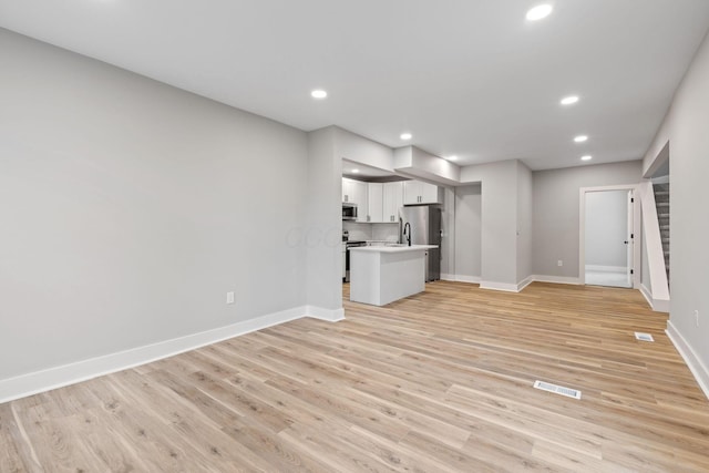 unfurnished living room with light hardwood / wood-style floors