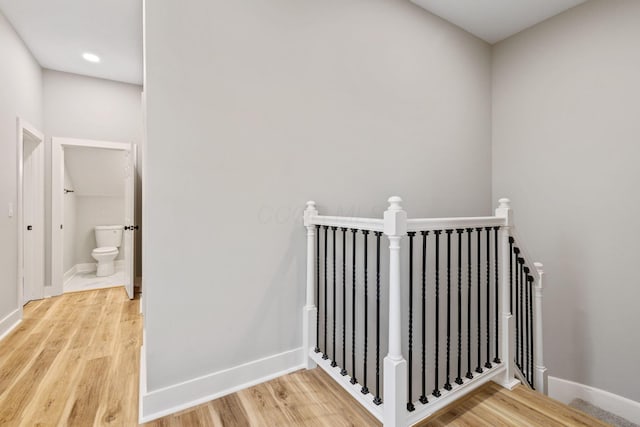 staircase with hardwood / wood-style floors