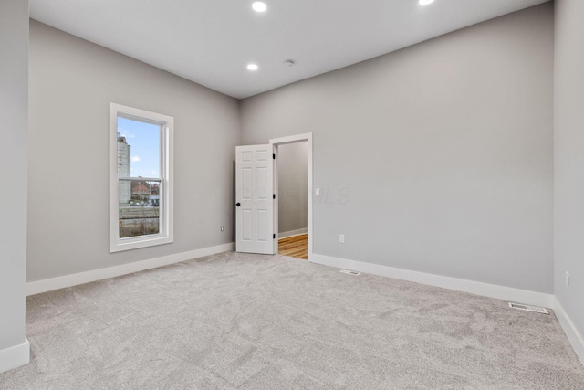 empty room featuring light colored carpet