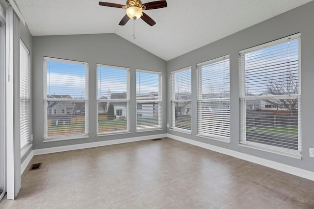 unfurnished sunroom with vaulted ceiling, ceiling fan, and a healthy amount of sunlight