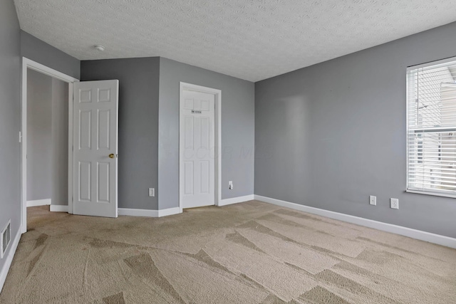 unfurnished bedroom with carpet flooring and a textured ceiling