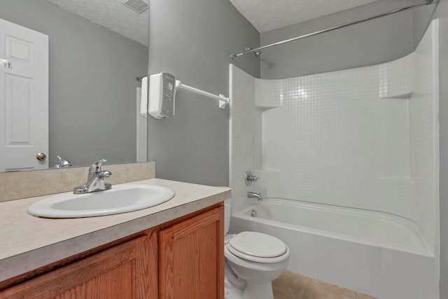 full bathroom featuring tile patterned floors, vanity, a textured ceiling, and toilet