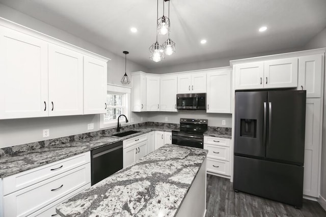 kitchen with sink, pendant lighting, white cabinetry, dark hardwood / wood-style flooring, and black appliances