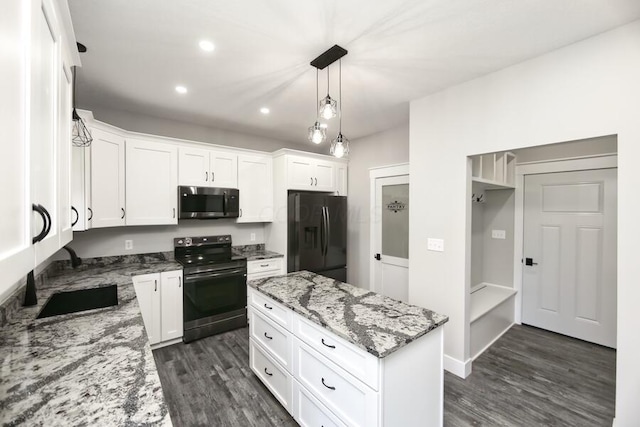 kitchen with white cabinetry, black appliances, and light stone countertops