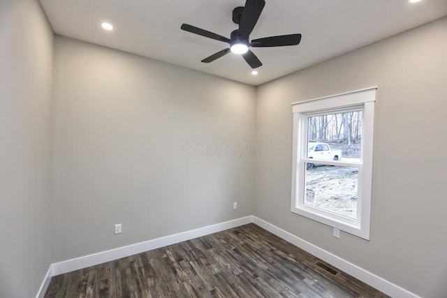 spare room with ceiling fan and dark hardwood / wood-style flooring