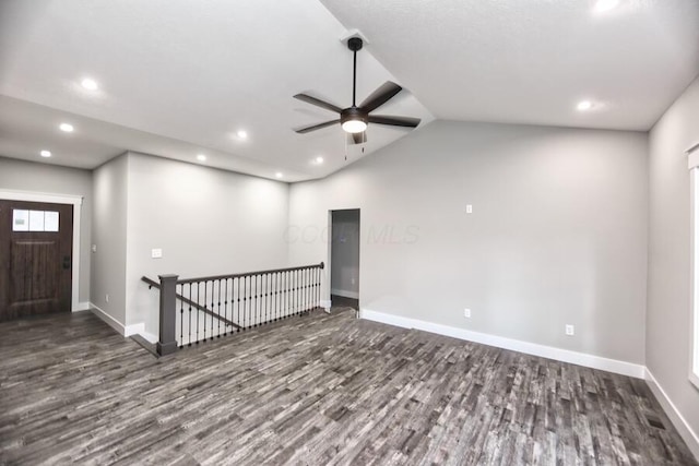 unfurnished room featuring ceiling fan, dark wood-type flooring, and lofted ceiling