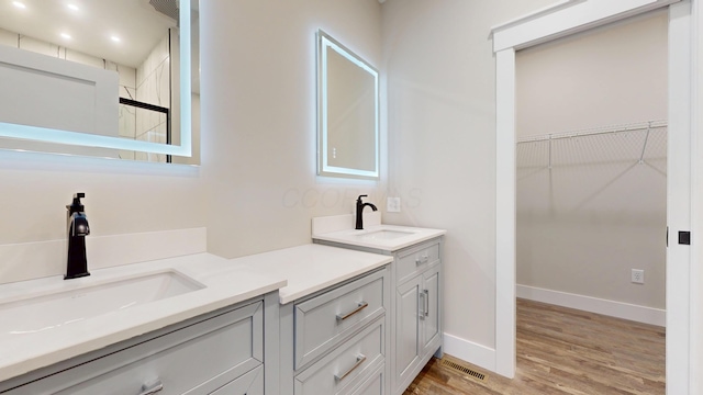 bathroom with vanity and hardwood / wood-style floors