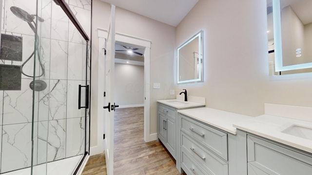 bathroom featuring hardwood / wood-style flooring, an enclosed shower, and vanity