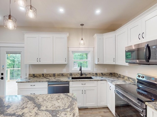 783 Crestrose Dr, Howard, OH 43028 - kitchen with stainless steel appliances, a sink, plenty of natural light, white cabinetry, and recessed lighting