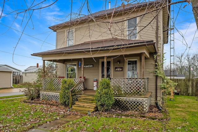 view of front of house with covered porch and a front yard