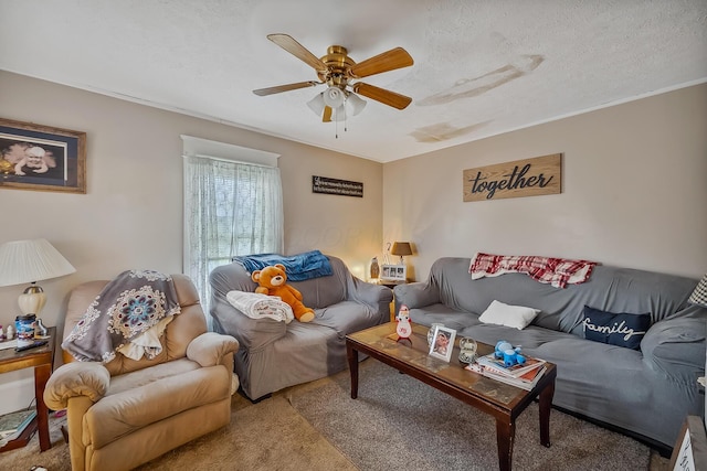 living room featuring carpet flooring, ceiling fan, and a textured ceiling