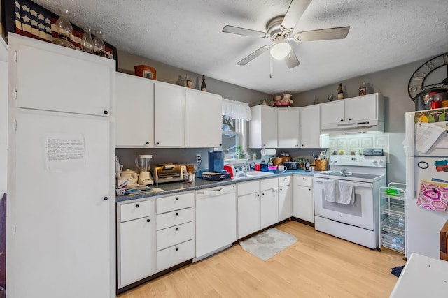 kitchen featuring a textured ceiling, white cabinetry, white appliances, and light wood-type flooring