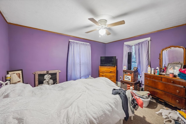 carpeted bedroom featuring ceiling fan and ornamental molding