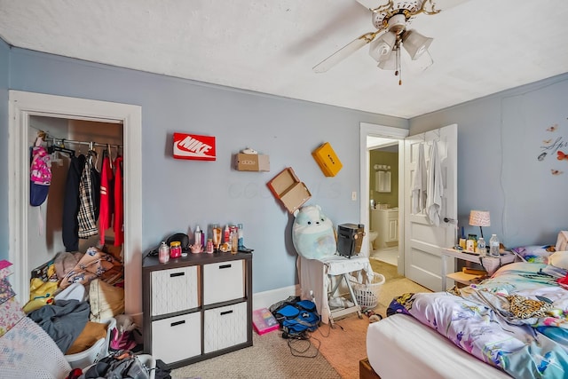 carpeted bedroom with ceiling fan, washer / clothes dryer, and a closet