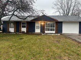 single story home featuring a garage and a front lawn