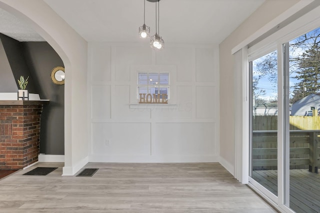 unfurnished dining area featuring light hardwood / wood-style floors