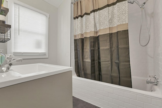 bathroom featuring shower / bath combo, a wealth of natural light, and sink