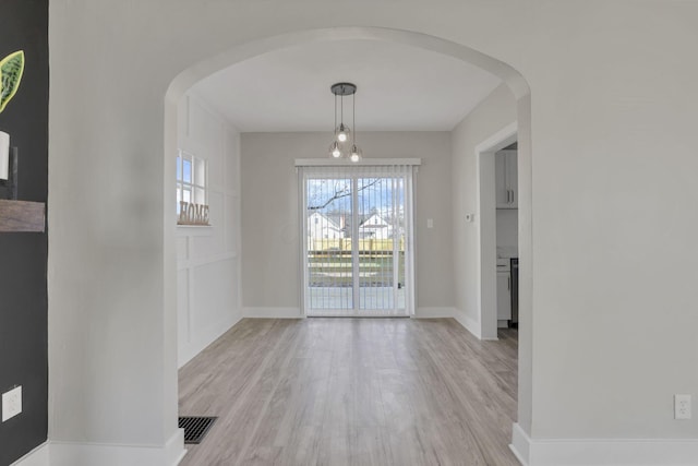 unfurnished dining area with light hardwood / wood-style flooring