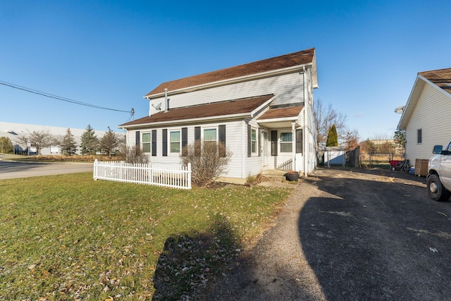 rear view of property featuring a yard