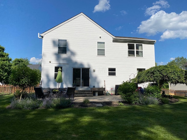 back of house featuring a patio and a lawn