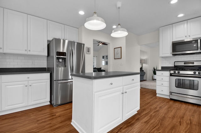 kitchen with ceiling fan, decorative backsplash, white cabinetry, and stainless steel appliances