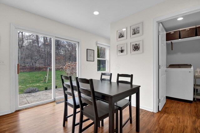 dining space featuring hardwood / wood-style flooring, a wealth of natural light, and washer / clothes dryer