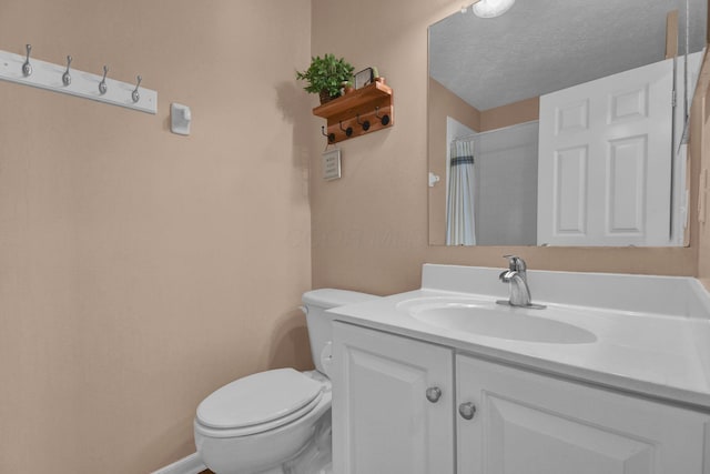 bathroom featuring vanity, a textured ceiling, toilet, and curtained shower