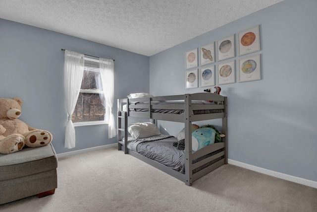 bedroom with carpet and a textured ceiling