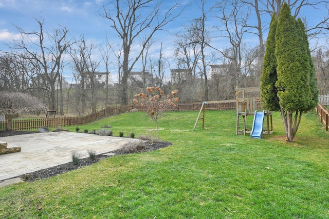 view of yard featuring a playground and a patio