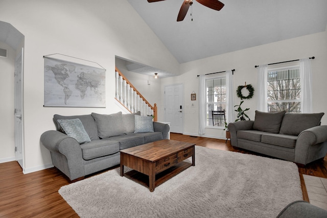 living room featuring ceiling fan, dark wood-type flooring, and high vaulted ceiling