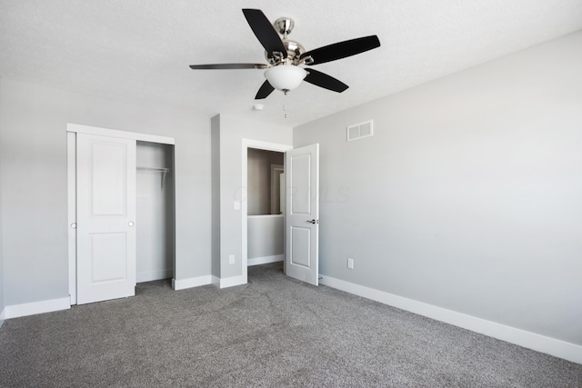 unfurnished bedroom with a closet, baseboards, visible vents, and carpet flooring