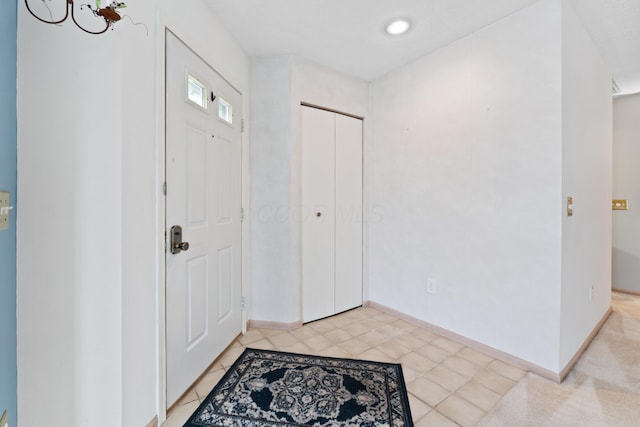 foyer entrance with baseboards and light tile patterned floors