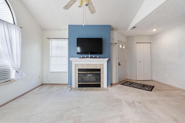 unfurnished living room featuring carpet, visible vents, a fireplace, and a textured ceiling