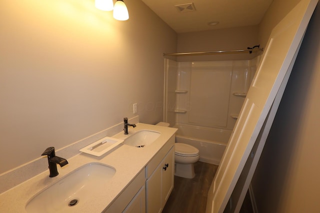 bathroom with visible vents, a sink, toilet, and wood finished floors