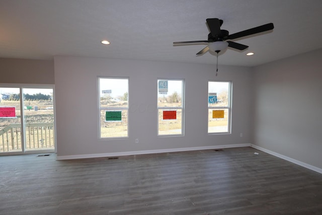 unfurnished room with dark wood-style floors, recessed lighting, visible vents, and baseboards