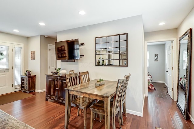 dining area featuring dark wood-type flooring