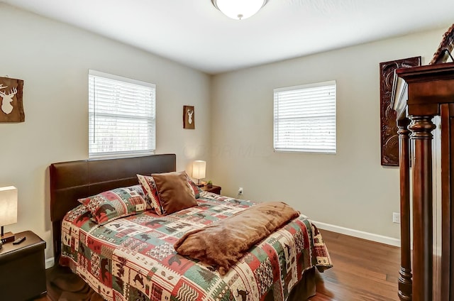 bedroom with dark hardwood / wood-style flooring