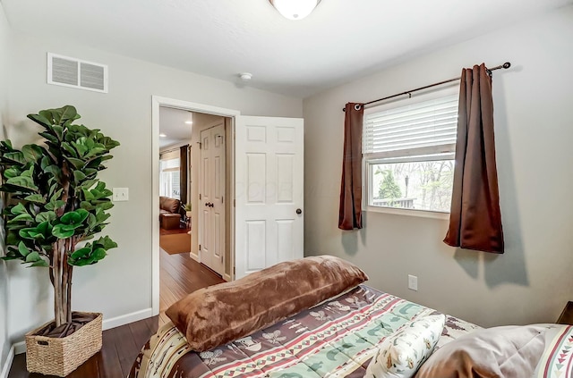 bedroom with dark wood-type flooring