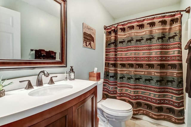 bathroom featuring vanity, a shower with shower curtain, and toilet