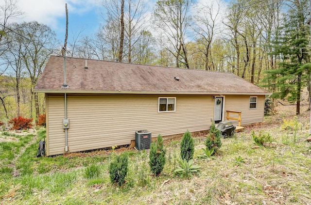 rear view of property featuring central AC