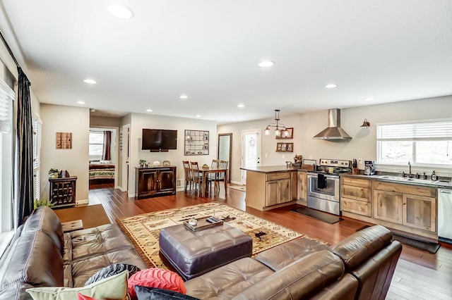 living room featuring light hardwood / wood-style floors, a healthy amount of sunlight, and sink