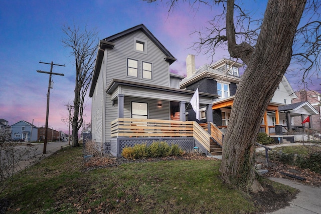 view of front of home featuring covered porch and a front yard