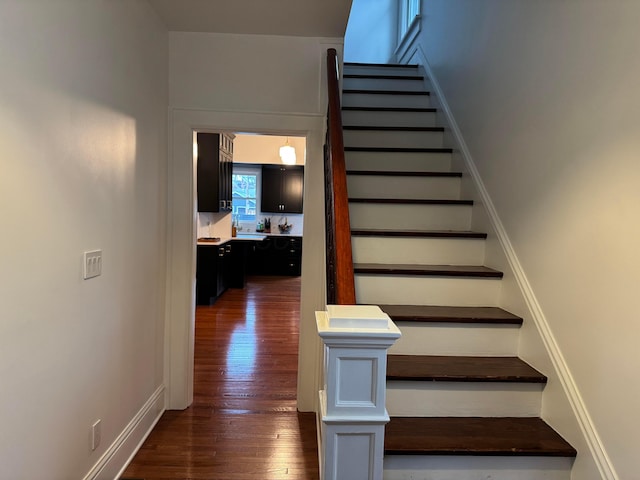 stairs featuring wood-type flooring